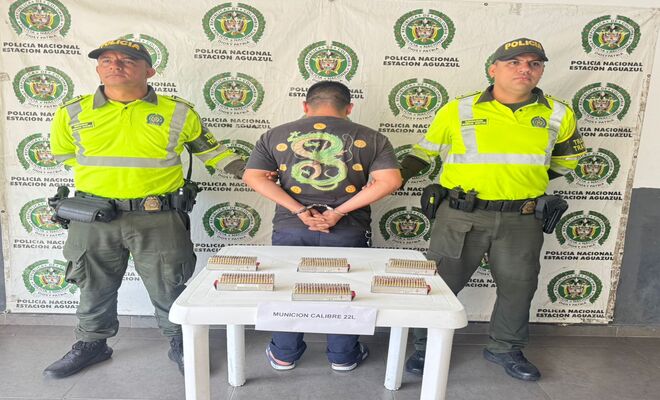Dos policías, un capturado sobre la mesa 600 cartuchos de armas de fuego