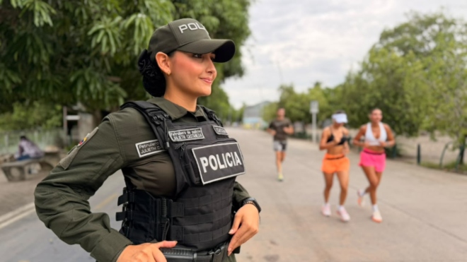Una uniformada de la Policía Nacional acompaña a tres ciudadanas mientras realizan actividad física, específicamente trote