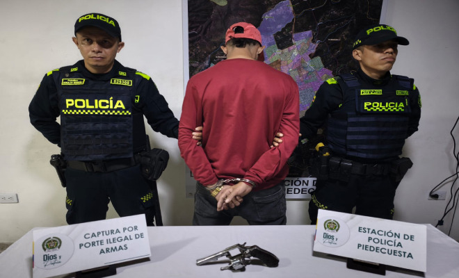 Hombre capturado en medio de dos Policías