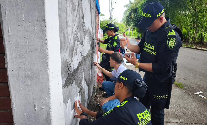 Policías realizando un manual junto a unas personas
