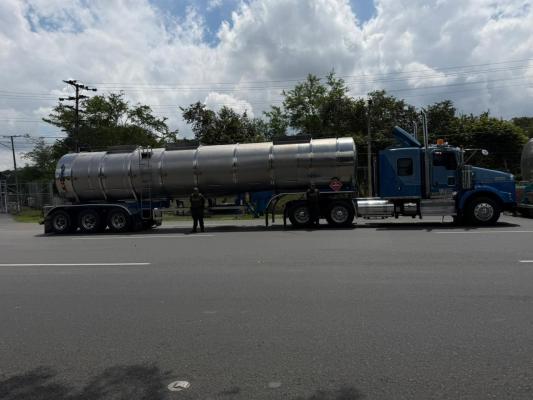 Policía al lado de un tractocamión 