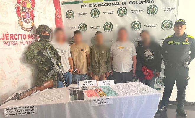 cinco capturados, un integrante del ejército, uno de la policía y elementos incautados encima de una mesa