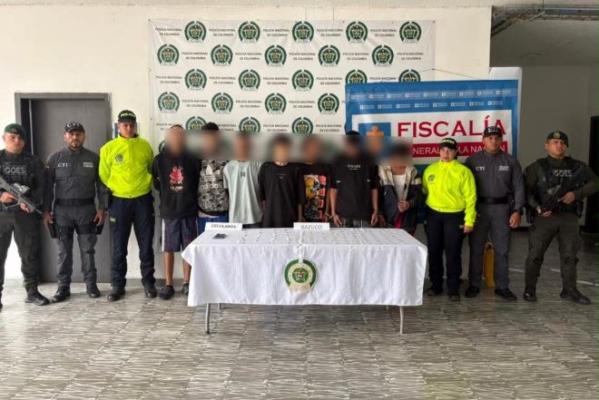 la policía nacional el CTI al lado de siete hombres capturados con material incautado