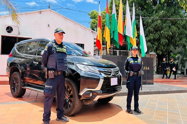 Dos policías junto a vehículo recuperado tras ser reportado como hurtado